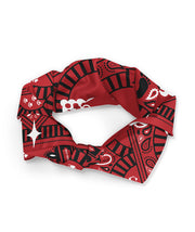 A red bandana with a black and white design on it. The design contains motifs from the show, Trolley Problems. The bandana is tied into a loop. From the Try Guys.