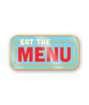 A hard enamel pin of the Eat the Menu logo. The pin has gold plating and the logo's blue and red colors. From the Try Guys.