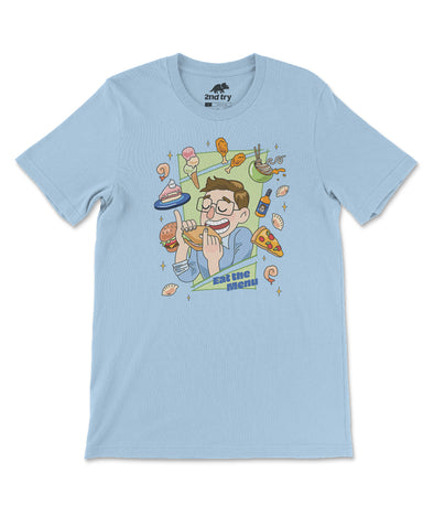 A light blue t-shirt with a design of Keith eating a sandwich while surrounded by a bounty of floating food. From the Try Guys.