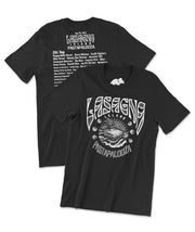A black t-shirt with a white design printed on the front and the back. The front of the shirts shows a music festival style graphic of a lasagna island floating in the sea, surrounded by text that reads, "Lasagna Island" and "Pastapalooza." The back of the shirt has a series of text. In large font is text that reads, "Aug 29, 2024, Lasagna Island Pastapalooza." Below that header is a long list of famous music artists whose names have been turned into pasta puns. From the Try Guys.