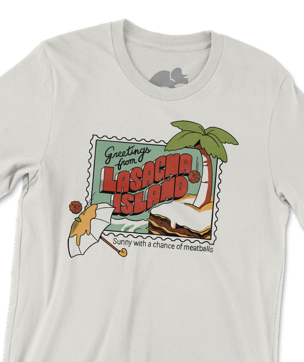 A close up of an off-white tshirt with a postcard style illustration on the front. It shows meatball falling from a palm tree on top of a piece of lasagna floating in the water. There is another meatball bouncing off of a cheese-covered umbrella. The text reads "Greetings from Lasagna Island: Sunny with a chance of meatballs". From the Try Guys.