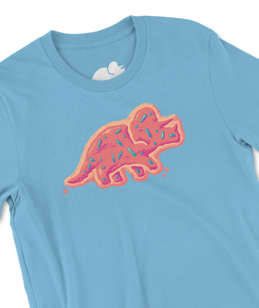 A closeup of a light blue t-shirt with a design on the front. The design is a stylized illustration of the Try Guys' triceratops logo, Stompy. Stompy is drawn to look like a frosted cookie with pink icing and sprinkles. From the Try Guys.