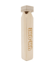 A wooden train whistle with the phrase "UH-OH!" engraved on one side. From the Try Guys.